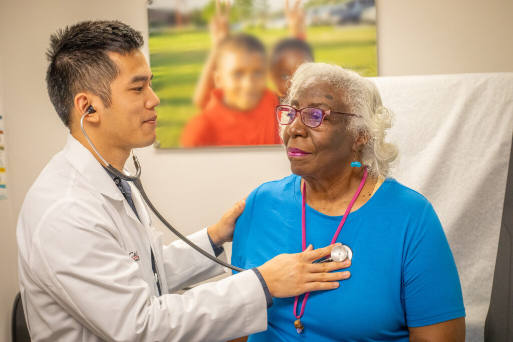 doctor checking up on elderly black woman