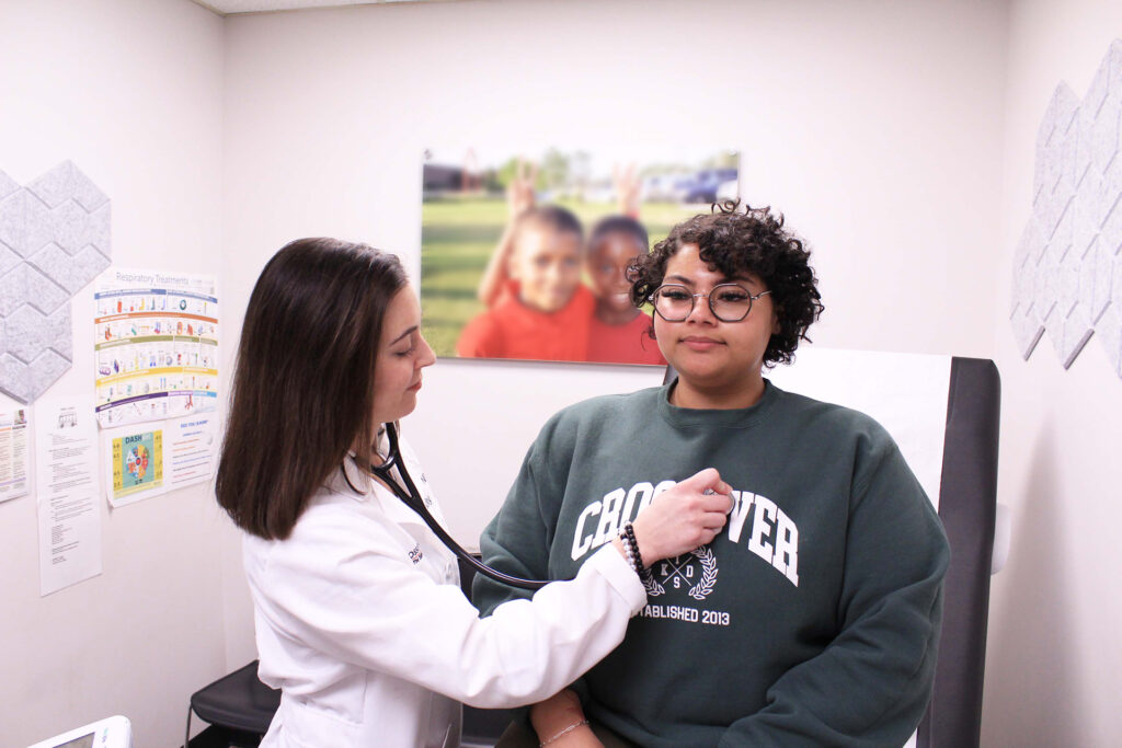 doctor taking patient's blood pressure